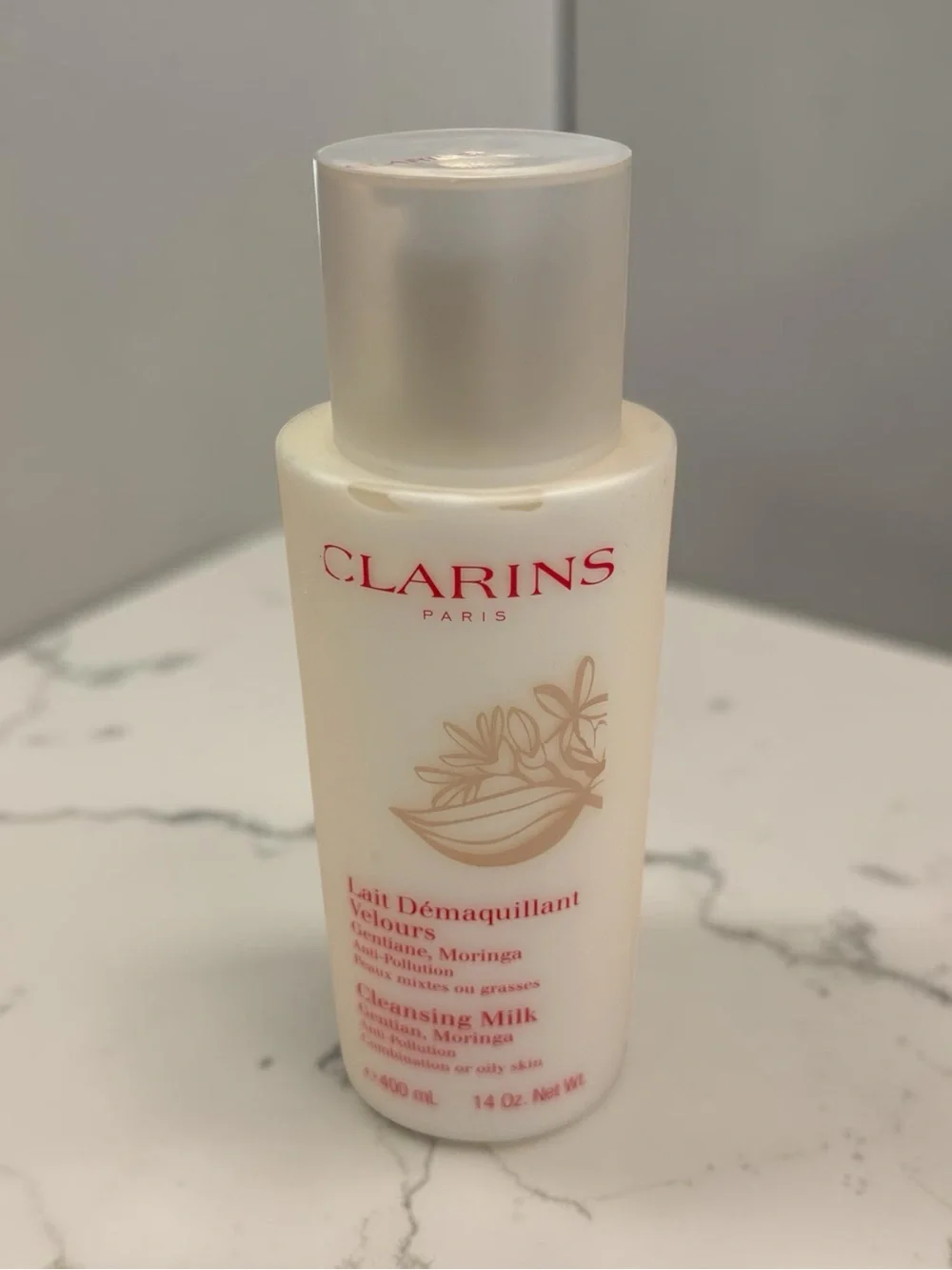 Clarins Cleansing Milk with Red Logo on Cream Bottle